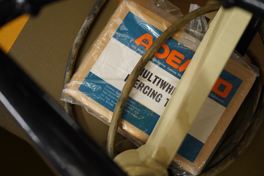 A collection of framing equipment to include Ademco heat press, C & H Bainbridge oval master mount cutter, Longridge baseboard, various mount and backing boards, tools, cutters, clamps and point drivers, many with instru